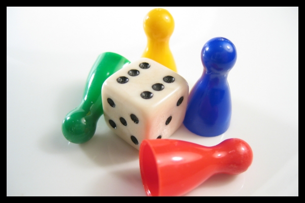 Classic board game pieces symbolizing simple gamification ideas for trade show exhibits.
