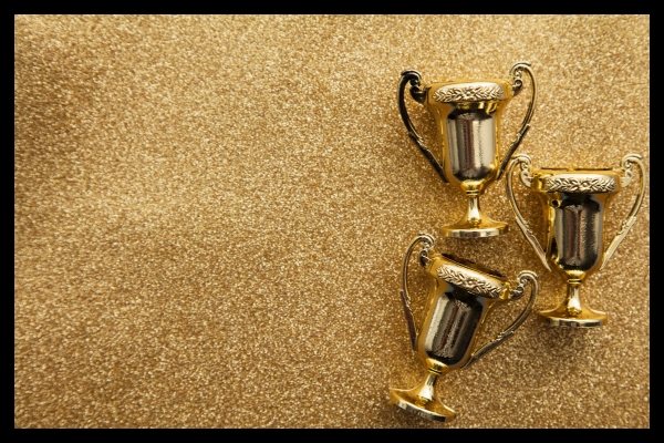 Gold trophies highlighting rewards in a live event gamification strategy.