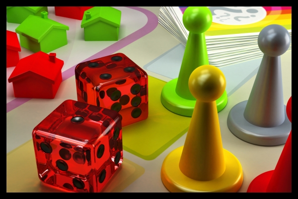 Dice and board game pieces used to represent gamified exhibit strategies at live events.